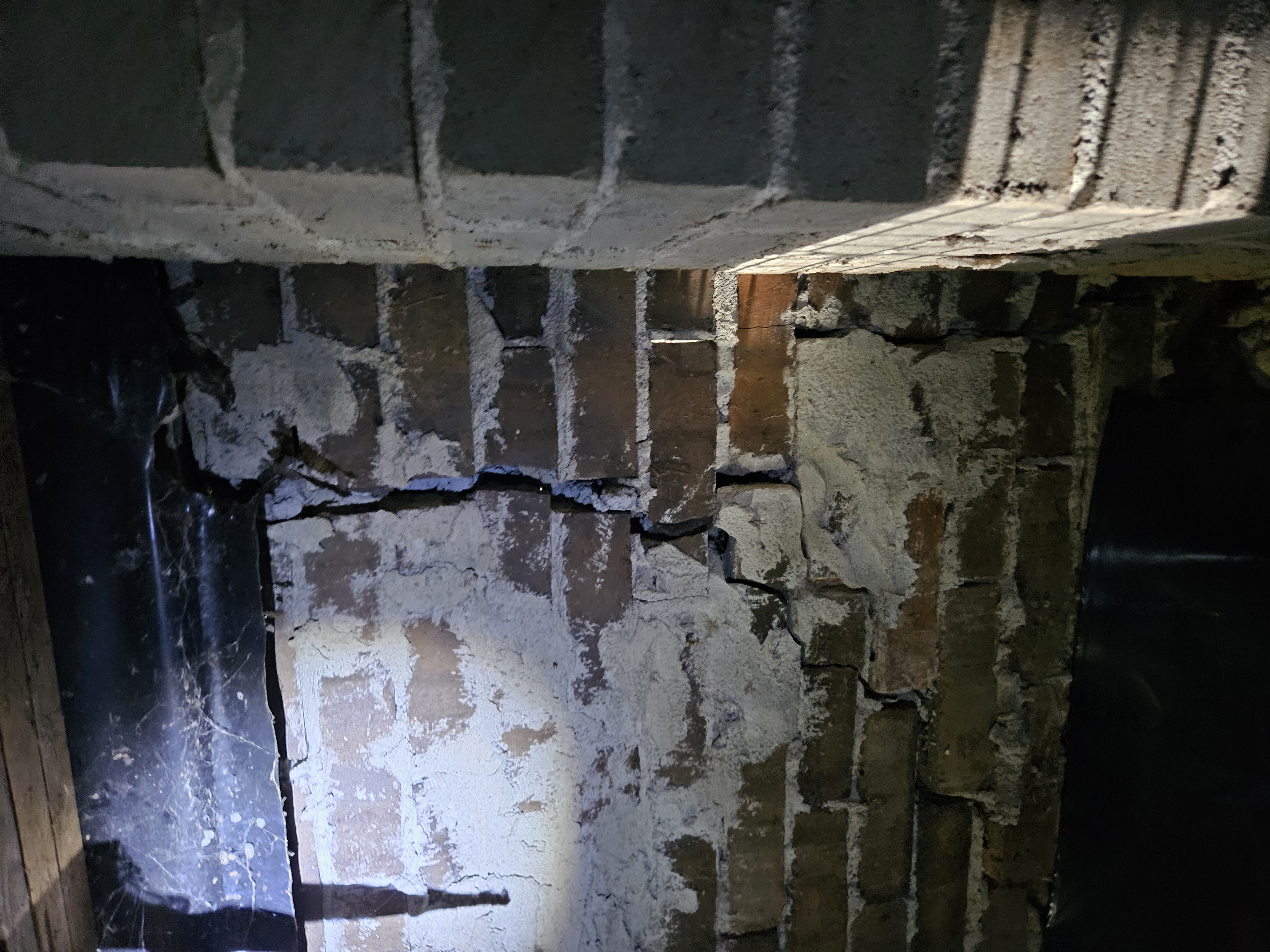 Severe foundation crack in crawl space brick pier — a costly repair missed by the naked eye.