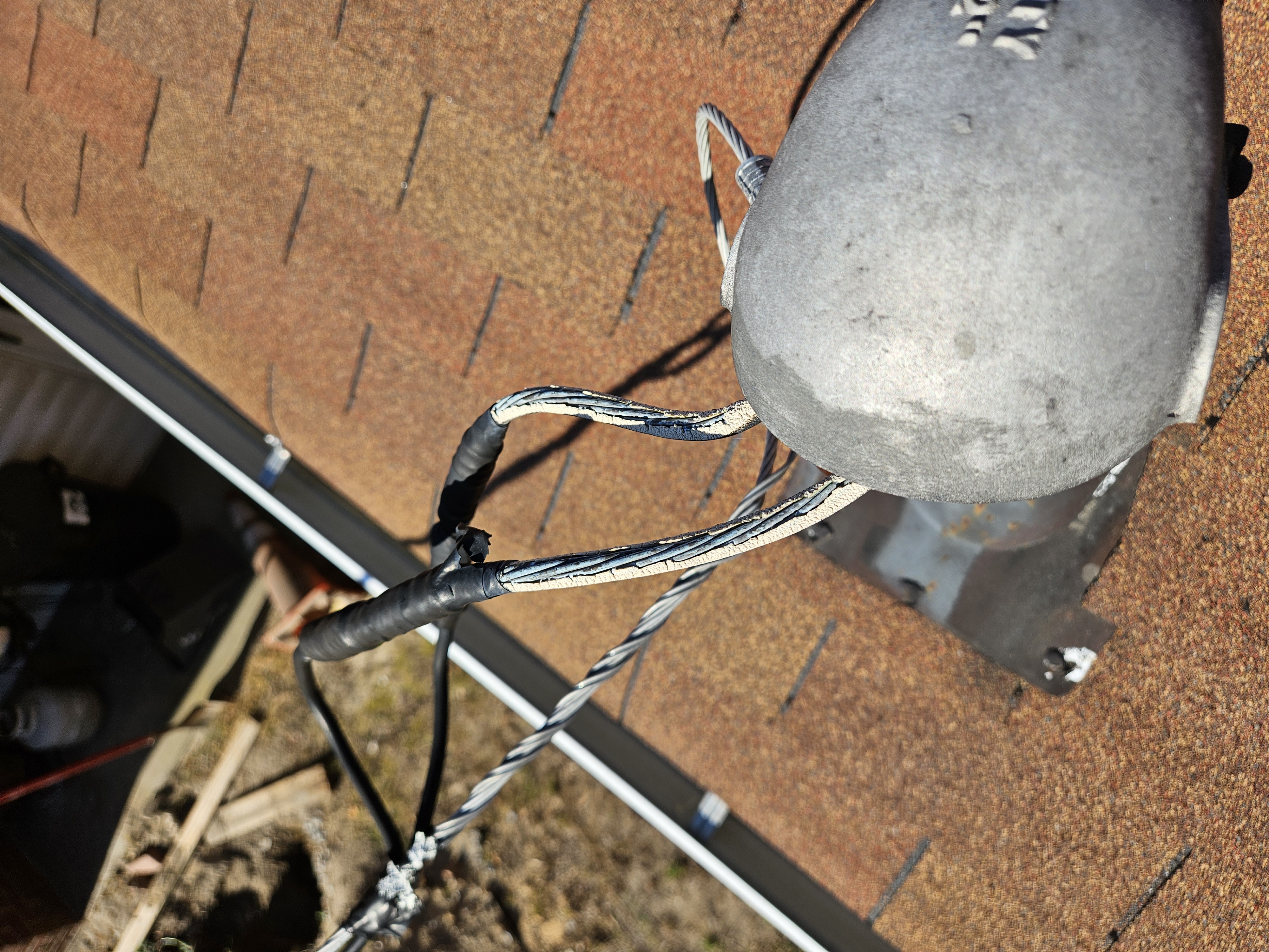 Severely frayed service entrance cables where insulation had completely failed at the weatherhead.